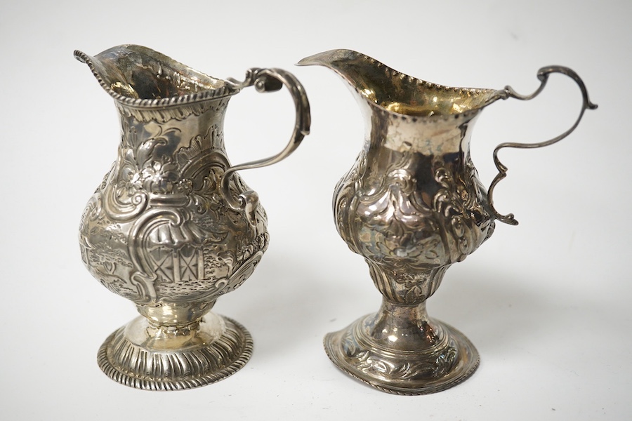 Two Georgian silver cream jugs, with later embossed decoration, inverted pyriform, London, 1782, the other London, 1773 (a.f.). Condition - poor to fair